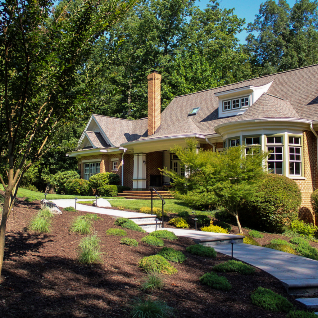 grounds management crew and landscape client with fresh landscape and walkway with railing