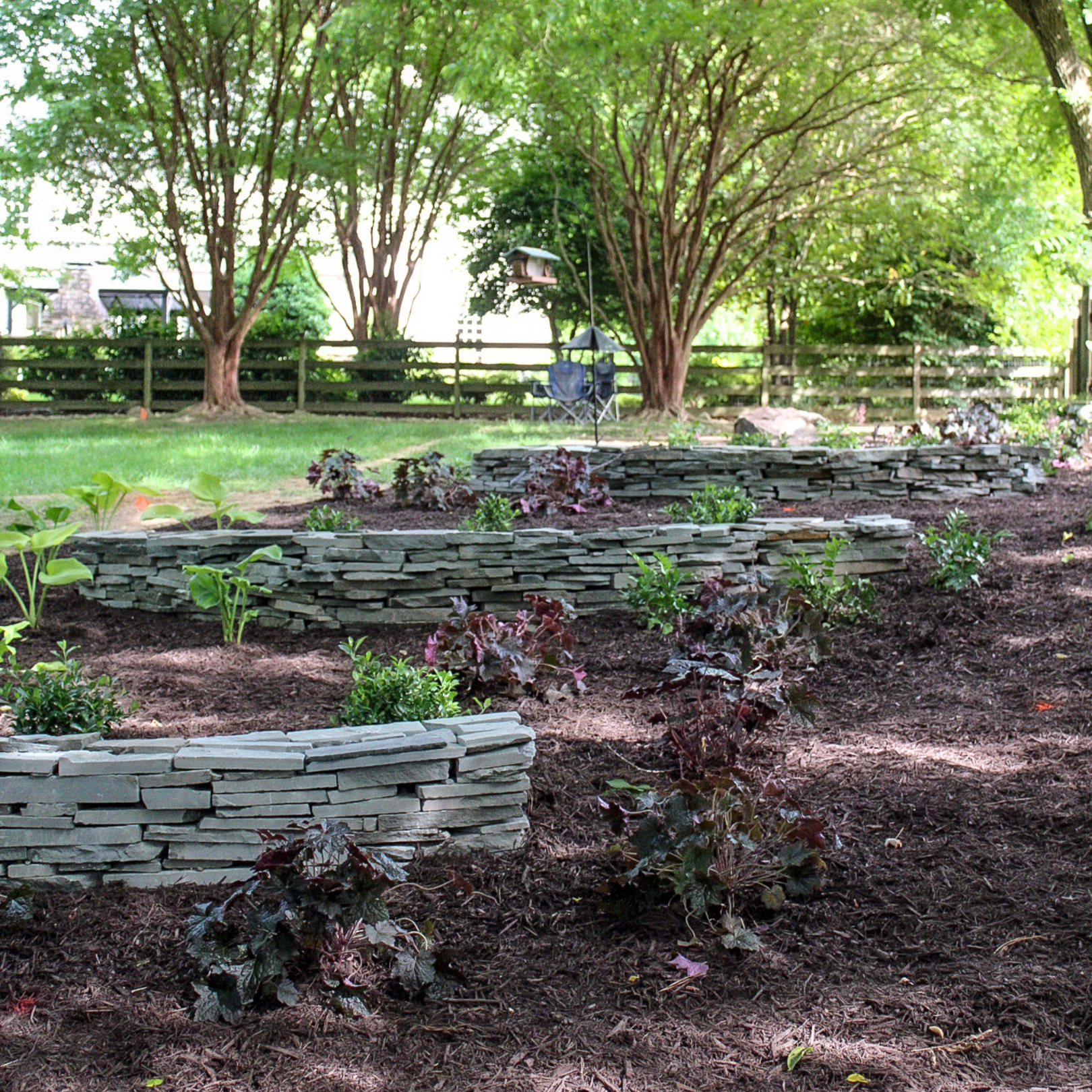 fresh landscaping with retaining walls to prevent erosion