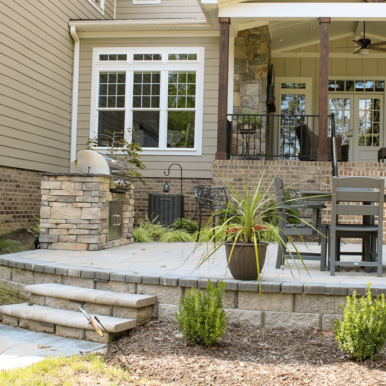 patio with outdoor kitchen grill and landscaping