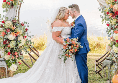 bride and groom at the alter with floral bouqet