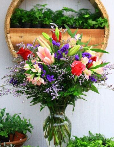 Beautiful floral vase with red, pink, and purple flowers.