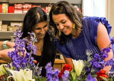 two women creating a floral design