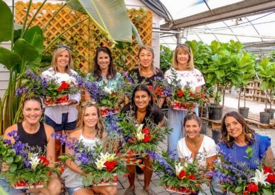 group of women posing with the their custom floral designs
