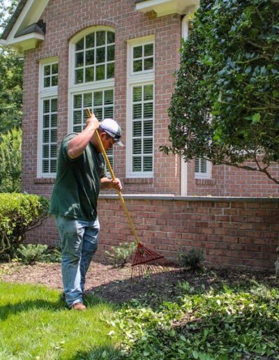 Cross Creek employee raking leaves.