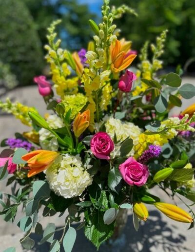 Floral arrangement with hydrangeas, roses, and snapdragons.