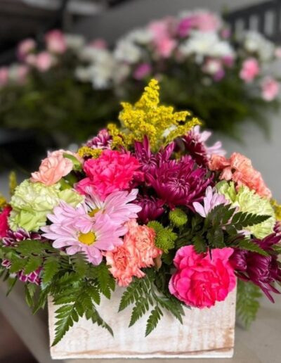 Floral white basket with colorful blooms.