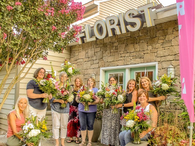 group of women in front of Cross Creek Florist after wine and design