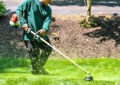 Cross Creek employee string trimming customers yard