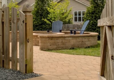 fence opening into a paver patio