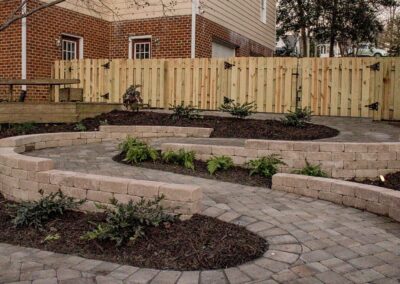 paver walkway with fence in background