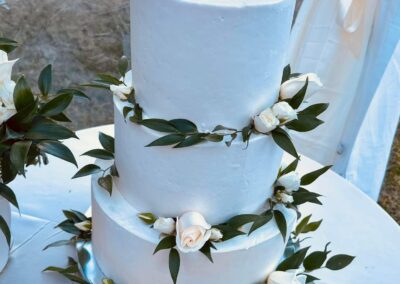 Private residence wedding cake with floral arrangements.