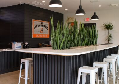 Commercial interiorscape with tropical plants cared for by maintenance staff.