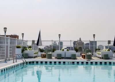 Pool area surrounded by healthy, thriving greenery in decorative planters.
