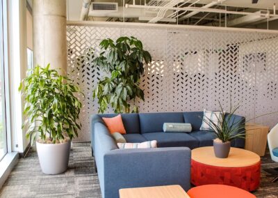 Modern office with lush indoor plants adding color and freshness to the workspace.